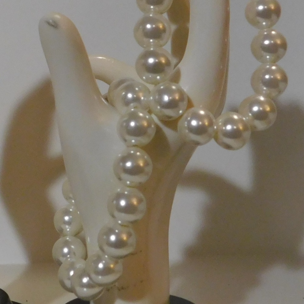 Two simulated pearl bracelets.